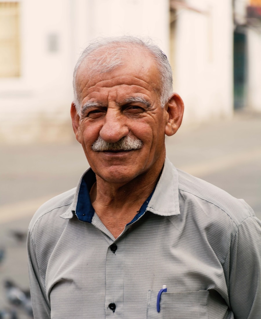 An older man smiling warmly, at ease in his own skin